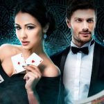 Two live casino dealers against a dark background.