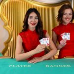 Two brunette live baccarat dealers