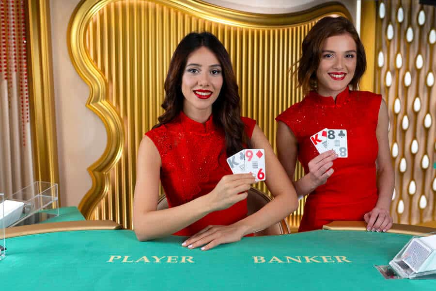 Two brunette live baccarat dealers