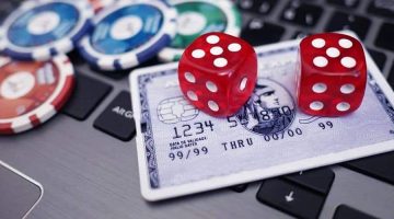 credit card play chips and dice on a laptop.