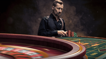 man at a roulette table placing bets