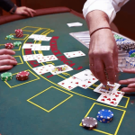 photo of a blackjack table with cards and chips