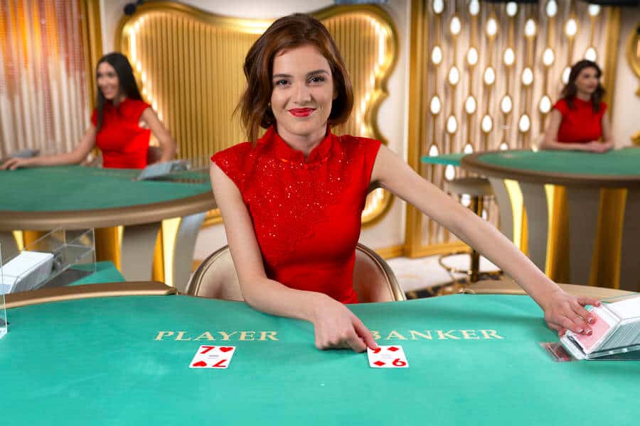 Brunette speed baccarat dealer pointing at card