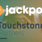 logos of SevenJackpots and Touchstone Partners on a green an orange background.