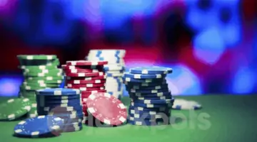 image of casino playing chips on a green felted table.
